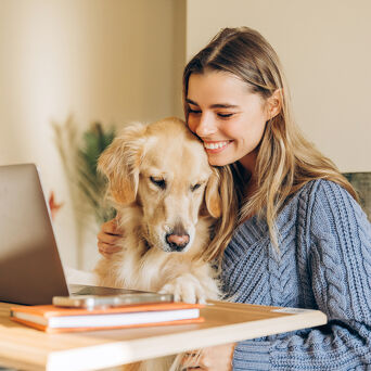 Woman Working From Home With Golden Retriever